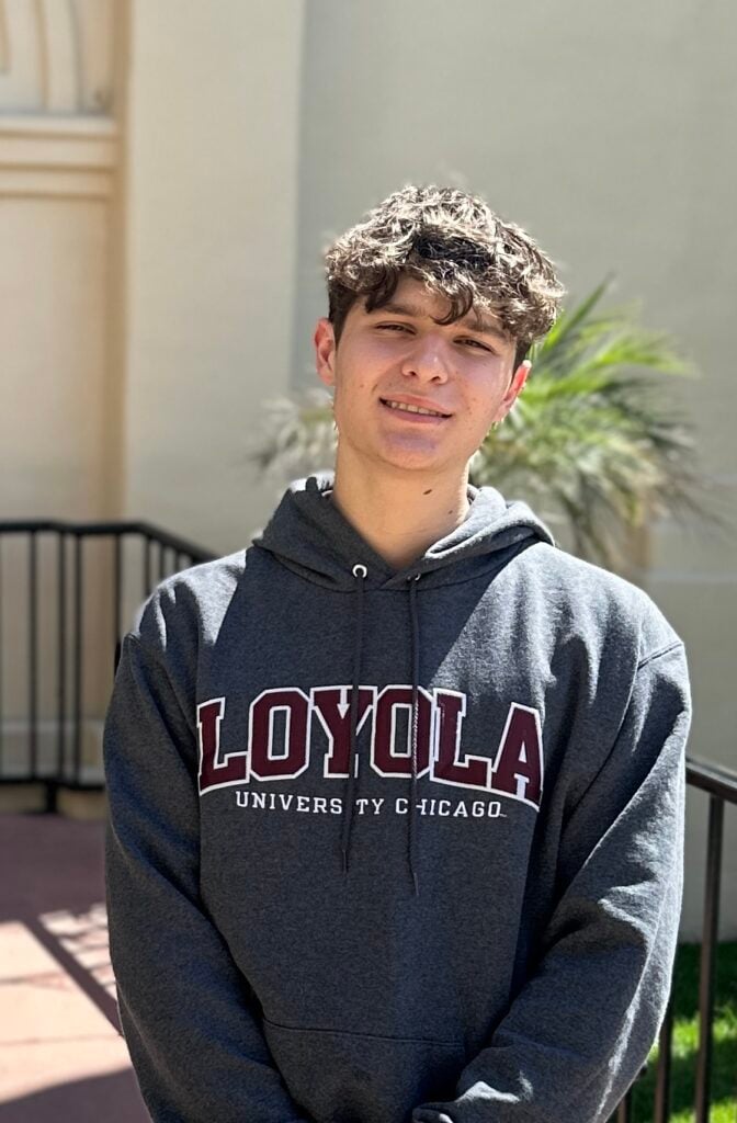 a young man wearing a loyola university of chicago hoodie